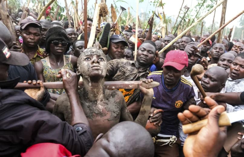 A mass circumcision is marketed to tourists in a remote area of Uganda. Some are angrily objecting